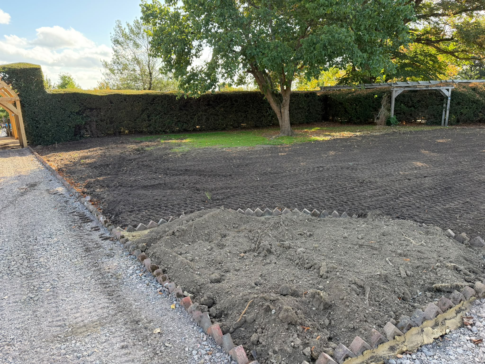 Garden excavation and ground preparation using machinery in Horley