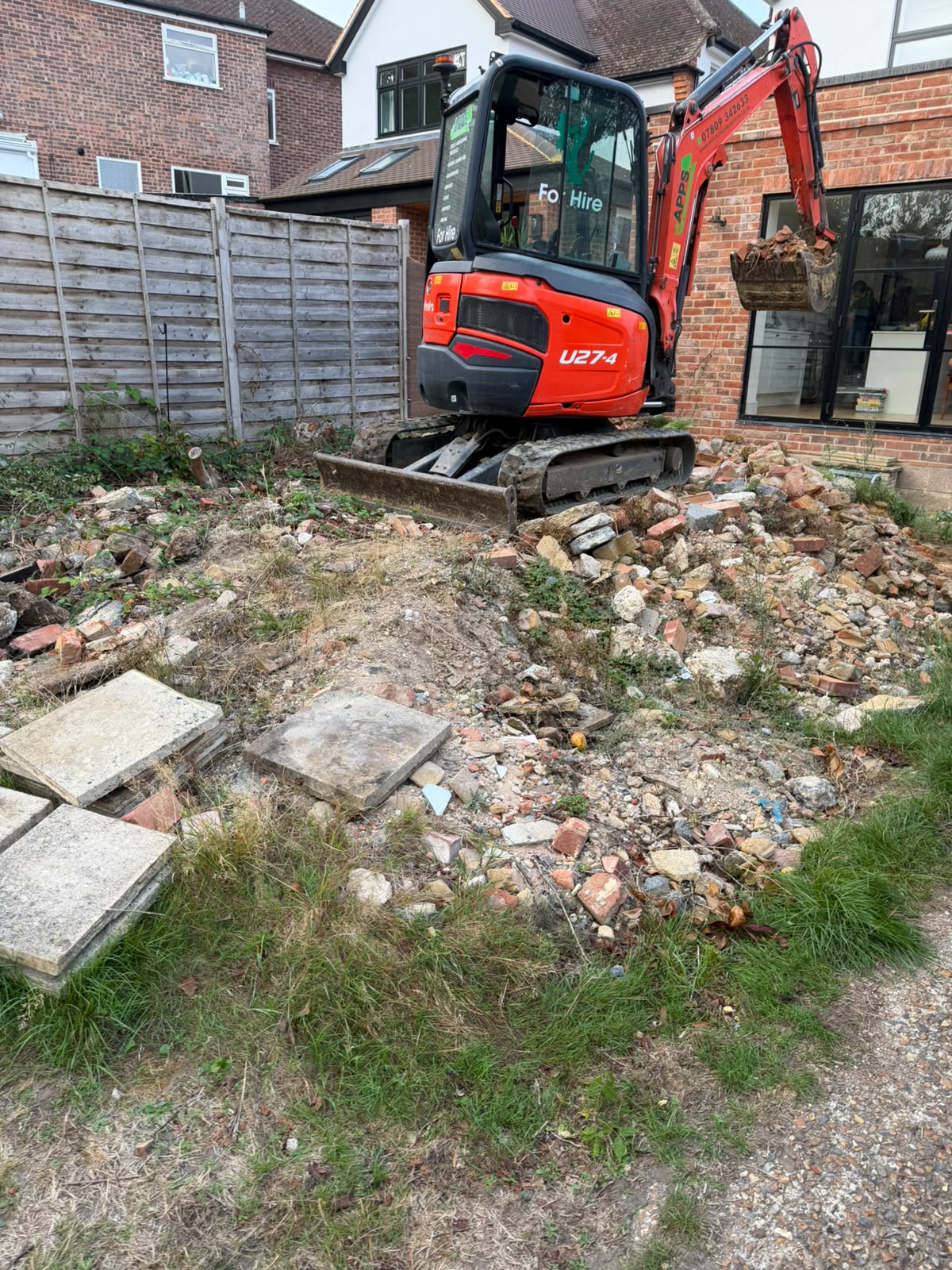 Groundwork contractors using a mini digger in Redhill