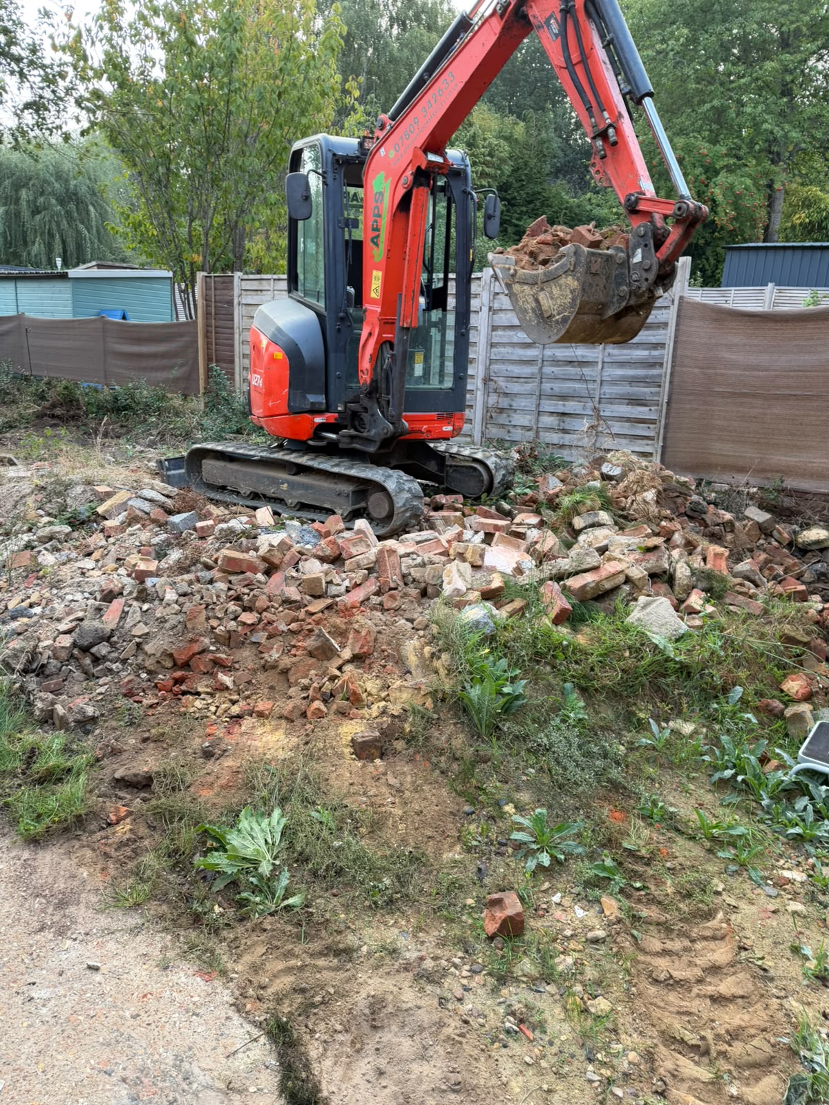Groundworks being completed with an excavator in Redhill